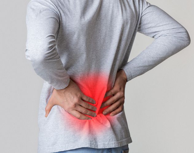 man holding back in pain with red highlighted area