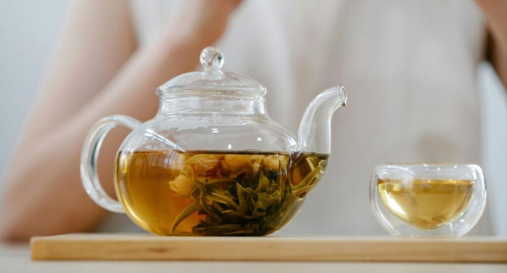 thca flower tea steeping in clear teapot