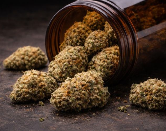 thca flower buds spilling out of an open glass jar