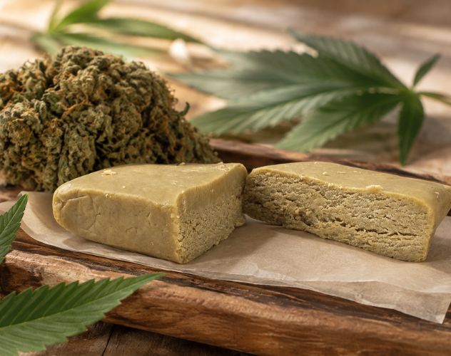 thca extract surrounded by thca flower buds and hemp leaves