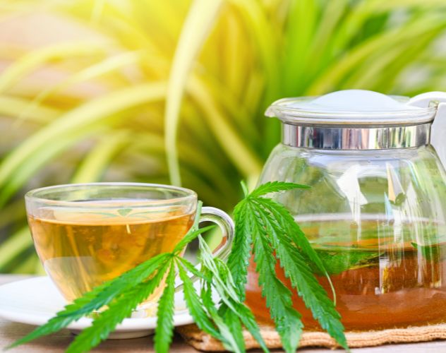 thca tea in a teapot and mug on a wooden ledge outside